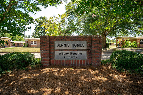 Brick sign stating Dennis Homes Albany Housing Authority